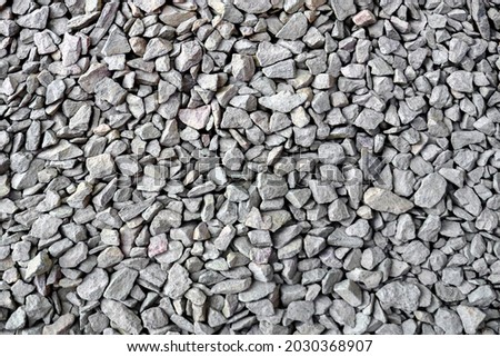Crushed rock close up. Small rocks ground. Crushed stone road building material gravel texture. Small stone construction material rock. Garden gravel background stone landscaping. Driveway gravel road Royalty-Free Stock Photo #2030368907