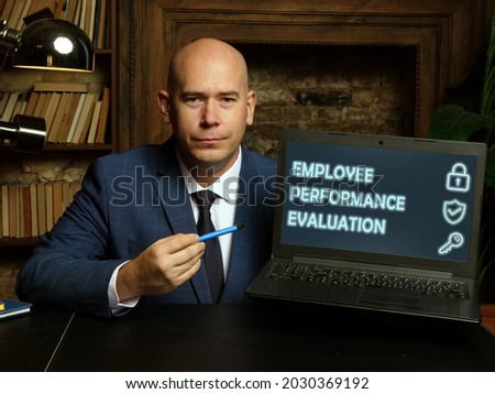 EMPLOYEE PERFORMANCE EVALUATION text in search bar. Budget analyst looking for something at laptop. EMPLOYEE PERFORMANCE EVALUATION concept. 

