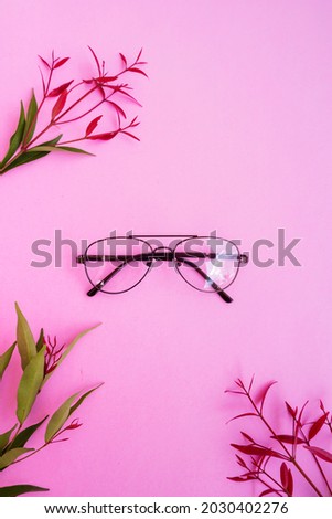 Stylish glasses over pastel background. Pink Pastel Color Paper.
