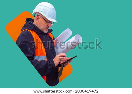 Builder man with a phone. Builder with blueprints on a turquoise background. Hard hat and construction uniforms on the builder. Construction uniform sale concept. Sale of protective uniforms Royalty-Free Stock Photo #2030419472