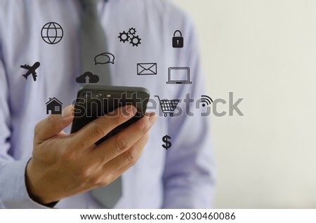 Hand holding smartphone with icons concept. Hand use smartphone online shopping Social media network concept.