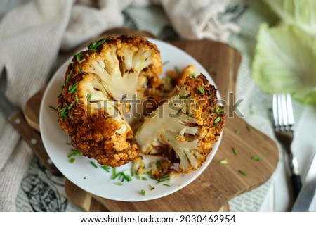 Baked cauliflower with turmeric. Delicious cauliflower. The perfect tasty snack. It tastes delicious with meat. Royalty-Free Stock Photo #2030462954