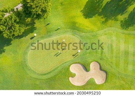 Golf course sport, green grass and trees on a golf field, fairway and putting green top view, Bangkok Thailand. bird view over Golf course in the tropical asia. Royalty-Free Stock Photo #2030495210