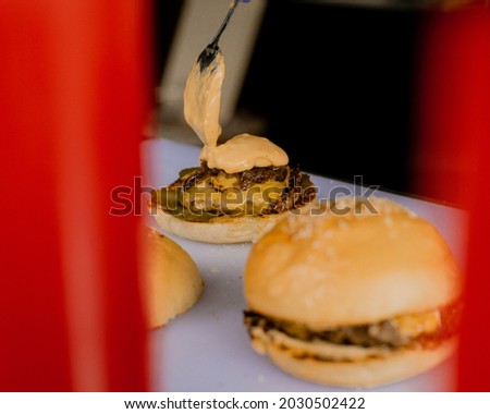 serving burgers, spread cheese sauce on top of the meat to serve