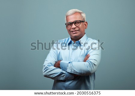 Portrait of a happy mature man of Indian ethnicity  Royalty-Free Stock Photo #2030516375