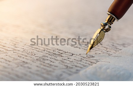 Fountain pen on an antique handwritten letter. Vintage nib pen and handwritten english cursive style font copperplate, spencerian. Old history background. Retro style. Royalty-Free Stock Photo #2030523821