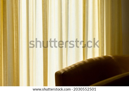 Empty chair yellow courtains sun light interior Royalty-Free Stock Photo #2030552501