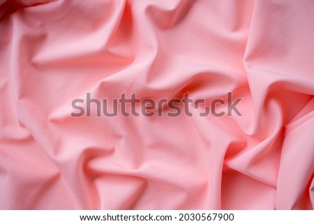 Orange fabric texture abstract background. new modern design luxurious light and soft wave smooth shape silk wallpaper. flat lay with free space. for card poster or presentation products concept.