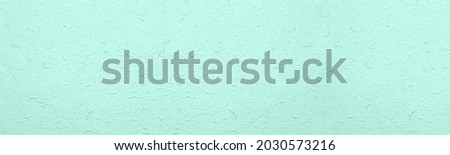 Rough crumpled surface large texture. Pastel mint green textured surface abstract wide background