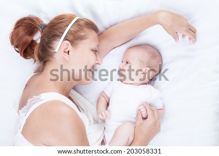 mother and newborn baby on white background
