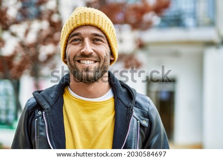 Handsome hispanic man with beard smiling happy outdoors Royalty-Free Stock Photo #2030584697
