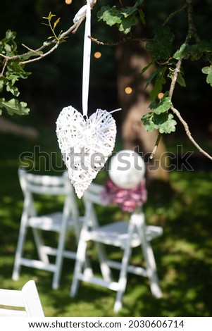 wedding chairs, set in rows outside in park, with handcrafted decorations. High quality photo
