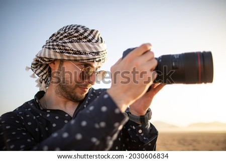 Young male photographer in the Wadi Rum Desert in Jordan.