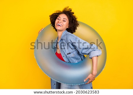 Photo of young happy dark brunette skin cheerful positive woman hold hand circle isolated on shine yellow color background