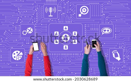 Top view of hands using mobile phone with symbol of influencer concept