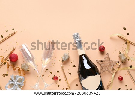 New Year composition with bottle of champagne on color background