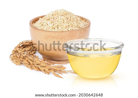 Rice bran oil extract with paddy and brown rice isolated on white background. Royalty-Free Stock Photo #2030642648