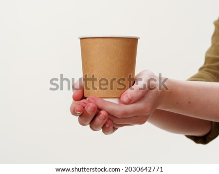 disposable coffee paper eco friendly cup in hand isolated on white background 2021