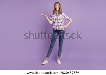 Full length photo of young girl show product promo offer advertise suggest isolated over violet color background