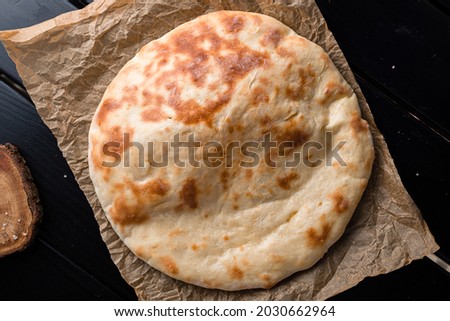 georgian traditional bread flatbread. Khychiny Traditional caucasian flatbread filled with cheese. top view, flat lay Royalty-Free Stock Photo #2030662964