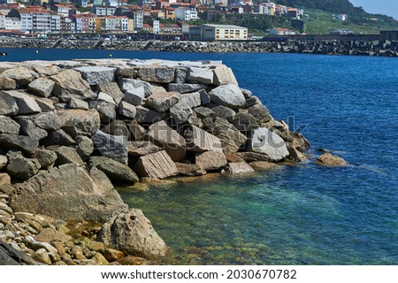 rocks arranged as breakwaters to protect the shoreline Royalty-Free Stock Photo #2030670782