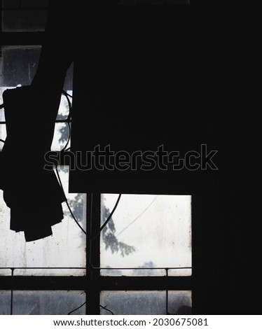 house window silhouette. taking photos from inside the house. abstract concept background.
