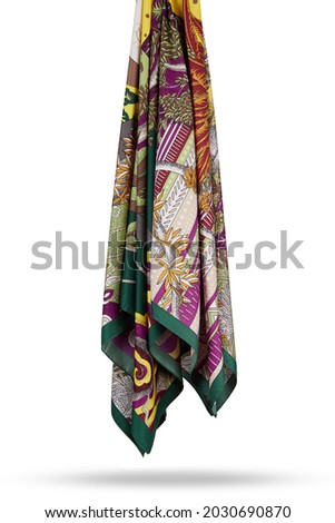 Subject photo of white and brown scarf with bright animalistic pattern. Stylish silk neckerchief is hanging on the white background.  