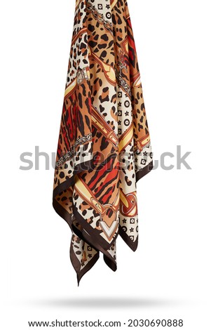 Subject photo of white and brown scarf with bright animalistic pattern. Stylish silk neckerchief is hanging on the white background.  