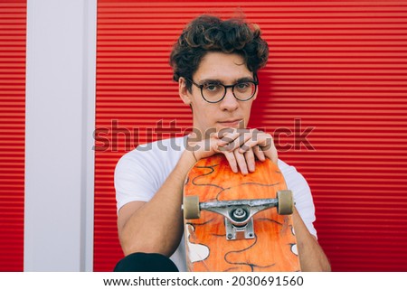 young man posing with his skateboard