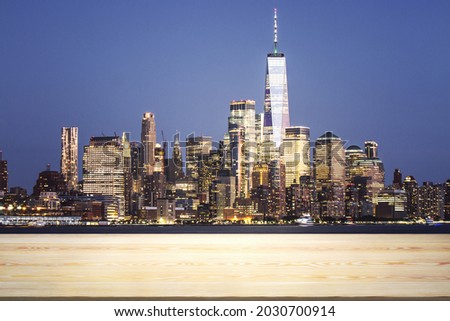 Blank wooden table top with beautiful New York skyline at evening on background, mockup