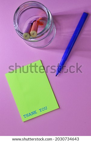 Thank You text words typography, Business Concept, Motivational concept. Marketing and Communications Concept. violet background, High angle view. yellow note paper
