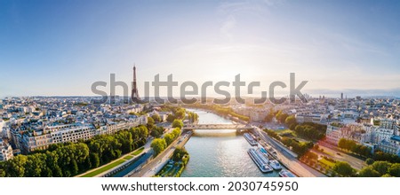 Paris aerial panorama with river Seine and Eiffel tower, France. Romantic summer holidays vacation destination. Panoramic view above historical Parisian buildings and landmarks with blue sky and sun Royalty-Free Stock Photo #2030745950