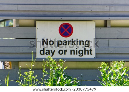 No parking day or night sign