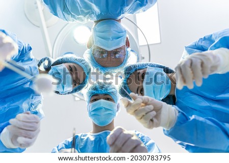 Medical Team Performing Surgical Operation in hospital operating. Medical team doing critical operation. Royalty-Free Stock Photo #2030783795