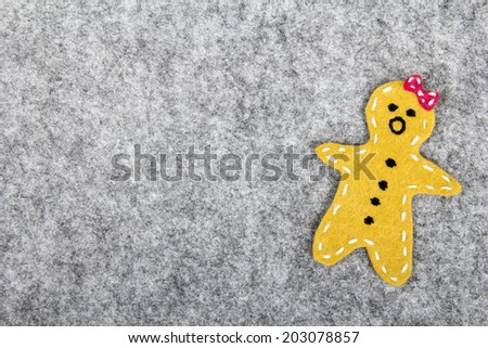gingerbread girl made of felt - christmas background