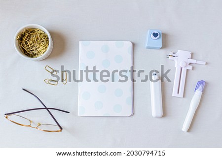 Home office desk. Women workspace with diary, stationery on white background. Top view, flat lay. Feminine concept.