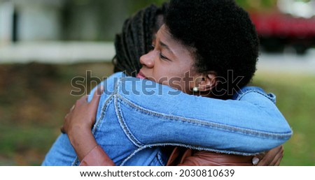 Depressed African woman, friend helping compassionate hug Royalty-Free Stock Photo #2030810639