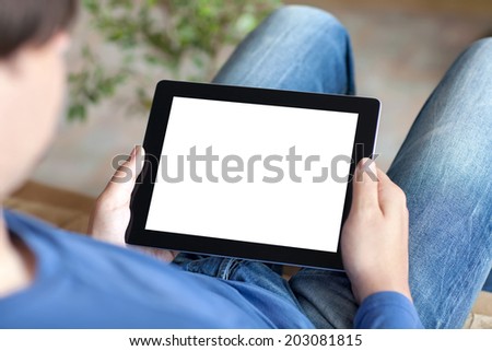 man sitting on a sofa and holding a tablet with isolated screen