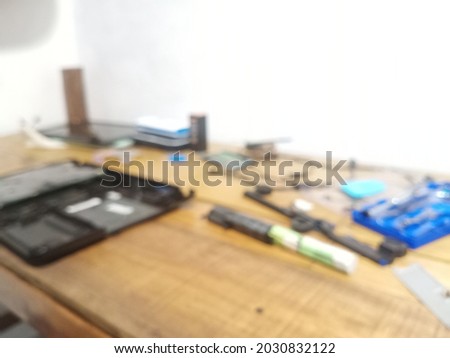 Defocused abstract background of wooden table and electronic service tools