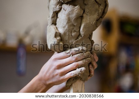 Female hands create a clay head sculpture in art studio
 Royalty-Free Stock Photo #2030838566