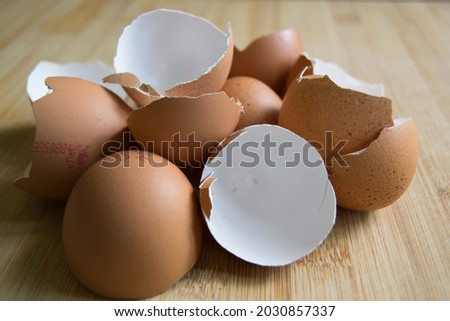 Brown speckled empty eggshells on the kitchen worktop  Royalty-Free Stock Photo #2030857337
