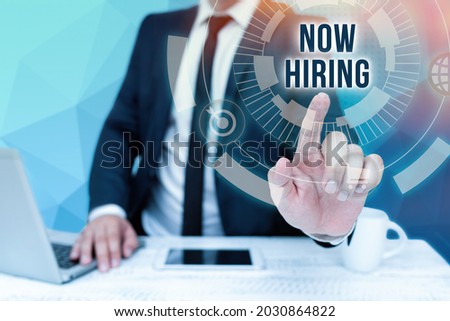 Handwriting text Now Hiring. Conceptual photo an act of starting to employ someone qualified for the position Bussiness Man Sitting Desk Laptop And Phone Pointing Futuristic Technology.