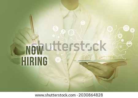 Text caption presenting Now Hiring. Conceptual photo an act of starting to employ someone qualified for the position Lady In Uniform Standing And Holding Tablet Showing Futuristic Technology.