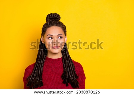 Photo of adorable pretty dark skin woman dressed red sweater smiling looking empty space isolated yellow color background