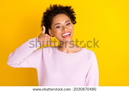 Photo of young happy positive cheerful woman call me gesture rest relax smile isolated on yellow color background