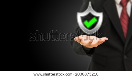 Certificate warranty mark secure access system. 
Business man holding shield protect the best. Royalty-Free Stock Photo #2030873210