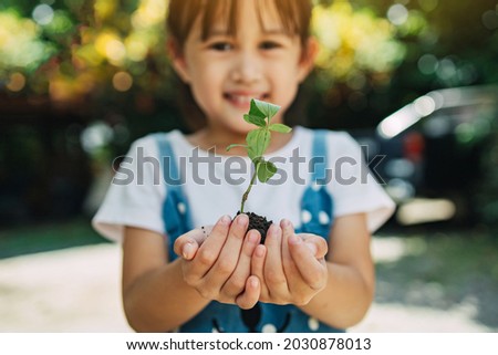 Cute kid planting a tree for help to prevent global warming or climate change and save the earth. Picture for concept of Earth Day to encourage people about the environmental protection.