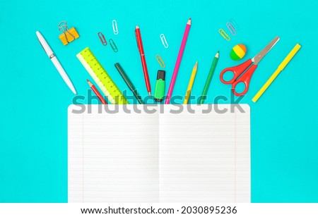 White Pure Striped Notebook and Stationery On Blue Background