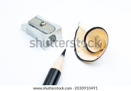 Sharpener and a broken pencil. Shavings and a graphite on white background. Close up, Macro photo. Back to school concept.