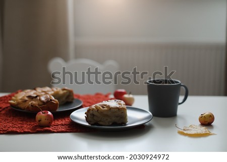 Breakfast with homemade apple pie and a cup of coffee on white table in a sunny morning